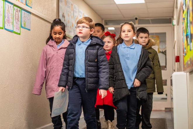 Children walking in school halway